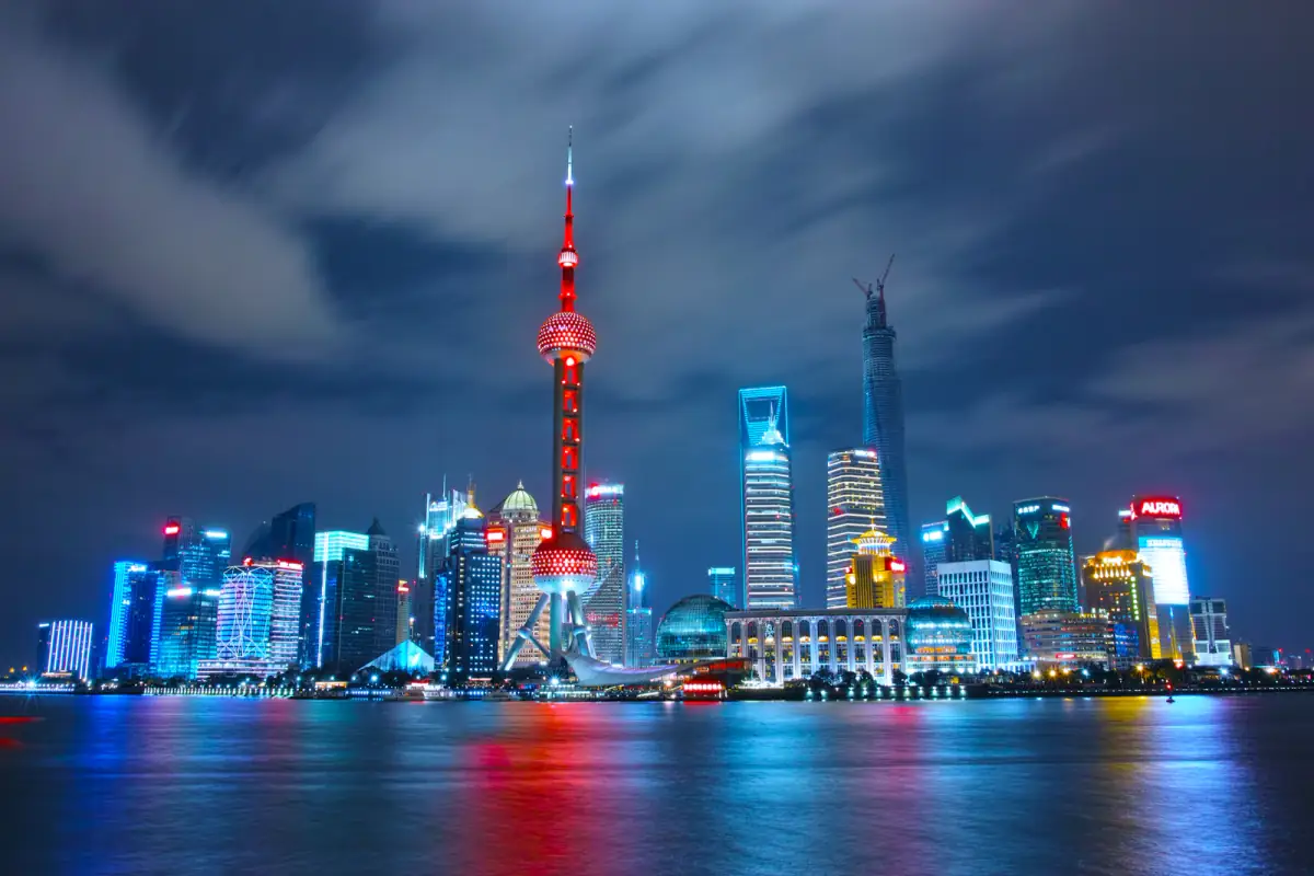 Shanghai skyline glowing across the Huangpu River after sunset